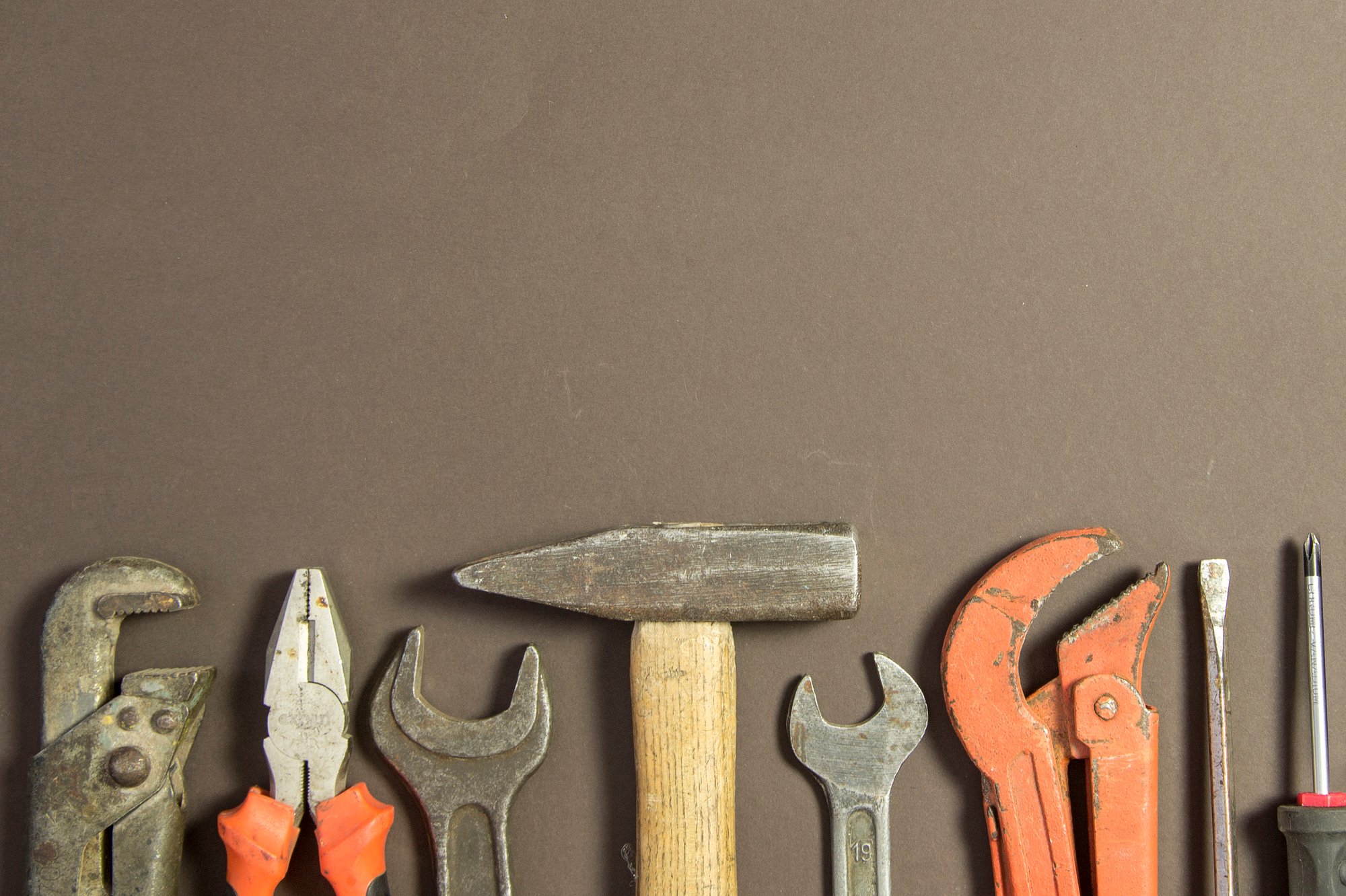 construction-tools-textured-grunge-paper-consisting-pipe-wrench-screwdriver-metal-hammer-free-copy-space-top